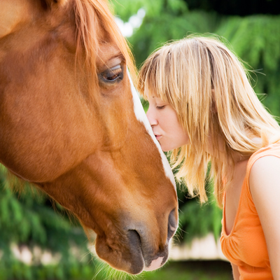 Woman kissing horse